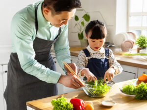 一緒に料理をするお父さんと小さな女の子