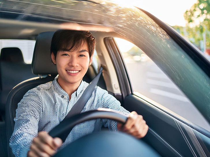 車を運転する若い男性