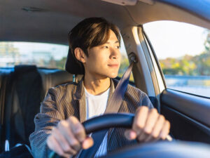 車を運転する若い男性