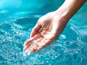 透明な水に浸された女性の手