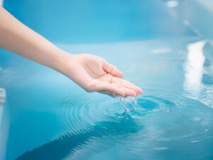 透明な水に浸された女性の手