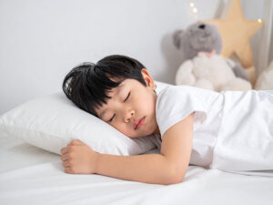 ベッドで眠る小さな男の子