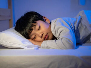 ベッドで眠る小さな男の子