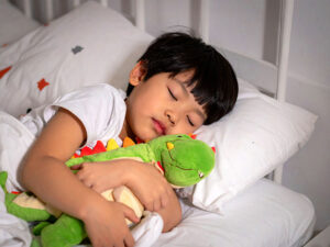 ベッドで眠る小さな男の子