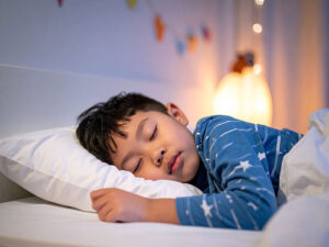 ベッドで眠る小さな男の子