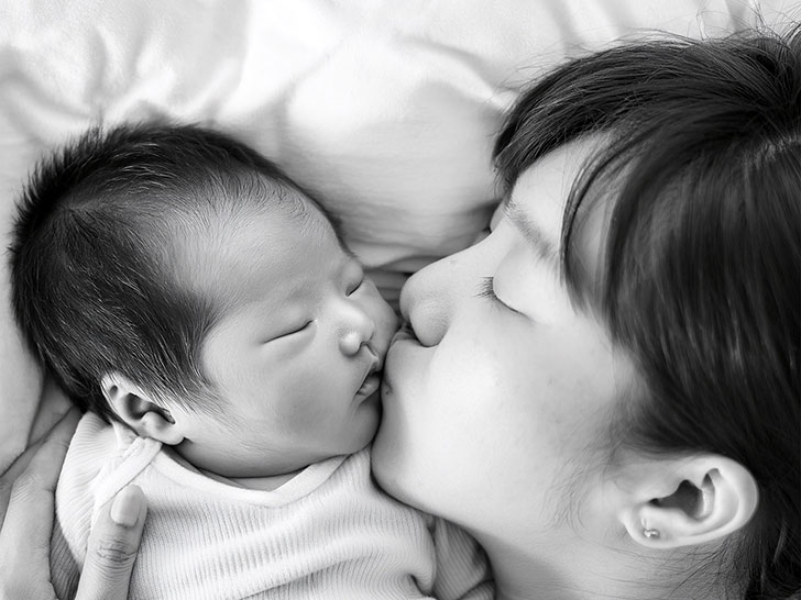 赤ちゃんと一緒に眠るお母さん