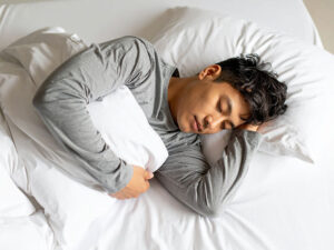 ベッドで眠る若い男性