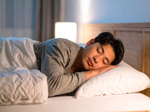 ベッドで眠る若い男性